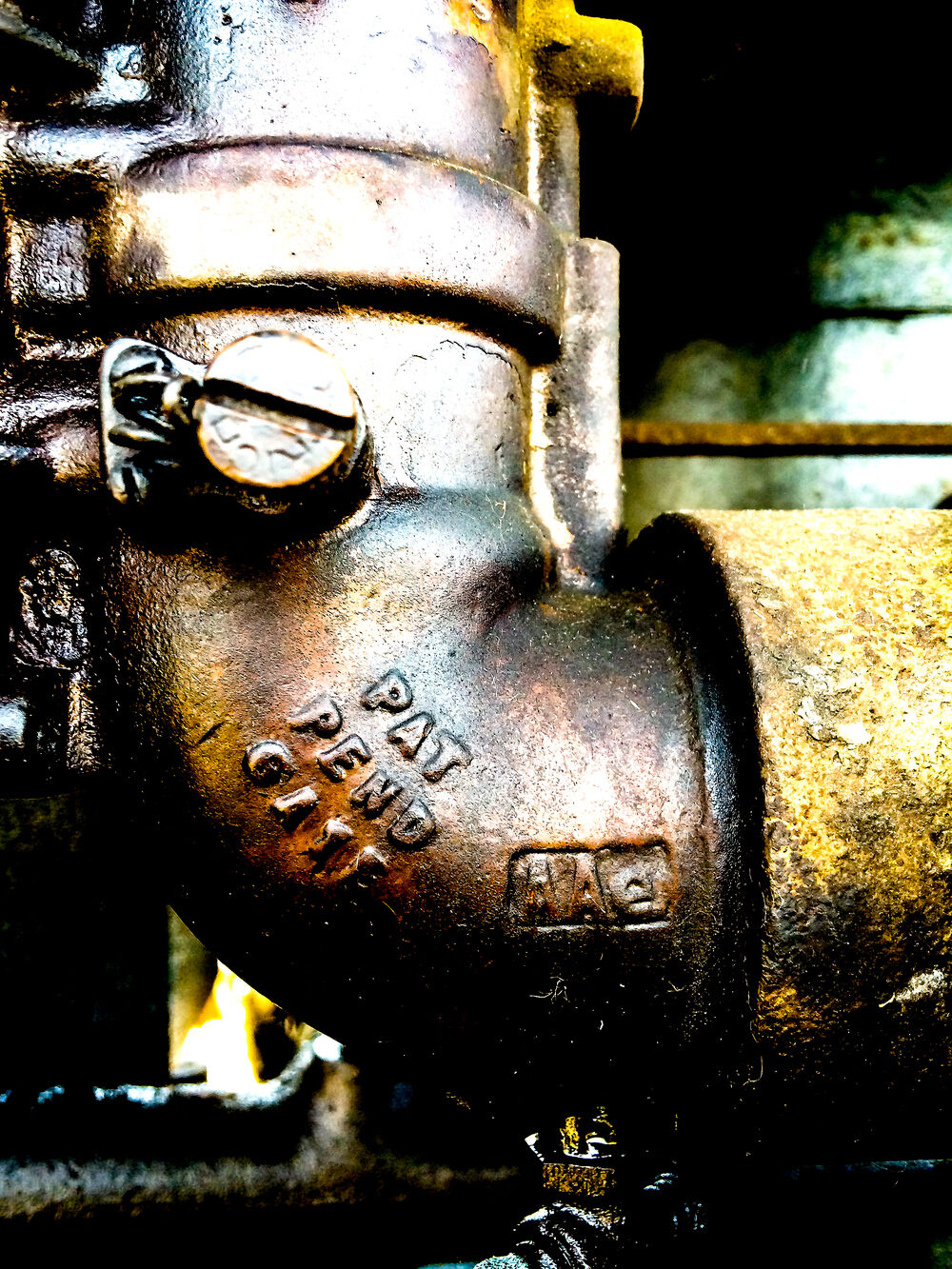 A metal pipe under the hood of a tractor includes a patent marking formed in the metal of an elbow in the pipe and reads "PAT PEND GATE".